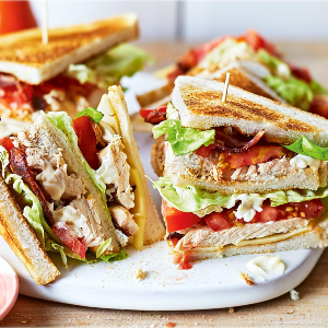 Photo of a sandwhich cut in half on a plate